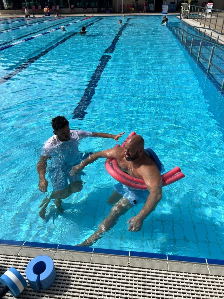 Physiotherapist Ben Strachan supporting a client in the water